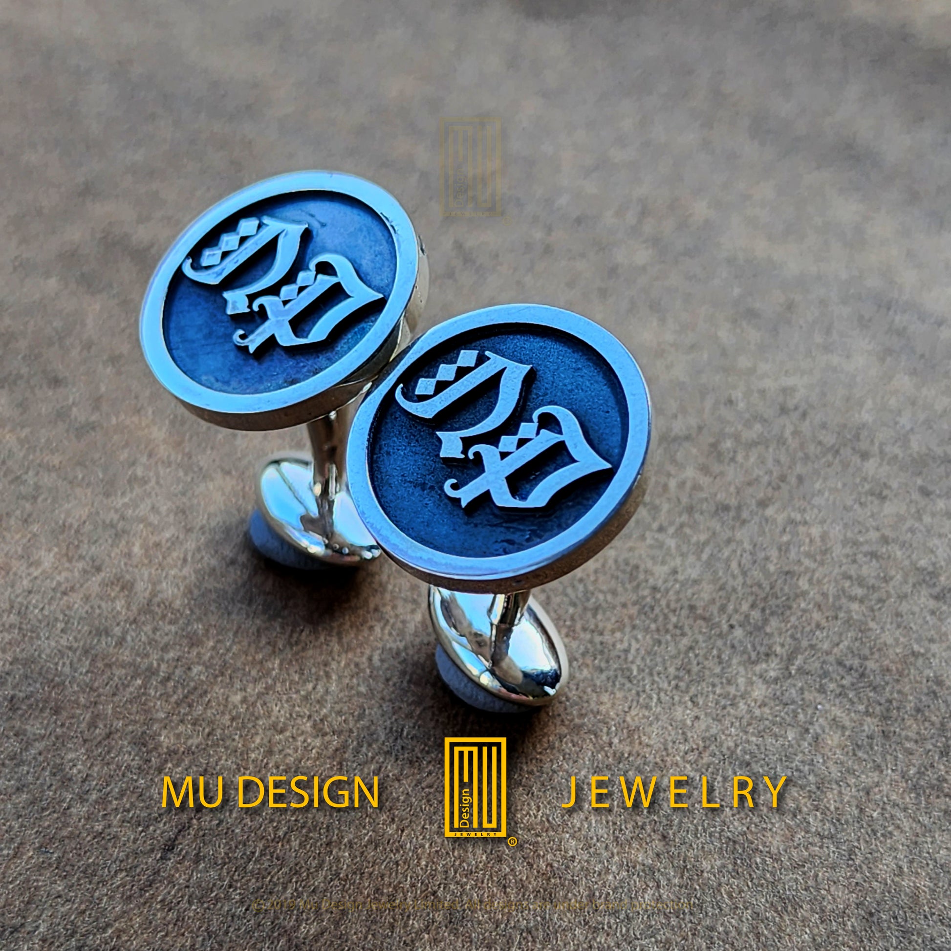 a pair of cufflinks with the word dad on them