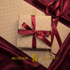 Mu Design Jewelry gift wrapping in patterned kraft paper with burgundy satin ribbon