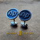 a pair of cufflinks with initials on them